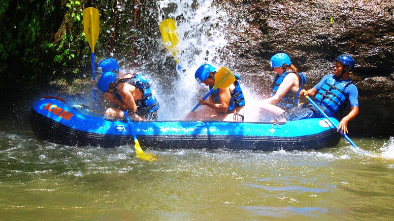 Rafters navigating gentle Grade 1 rapids on a Bali river