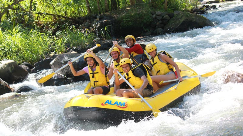 Joyful group of rafters conquering Grade 2 rapids in Bali