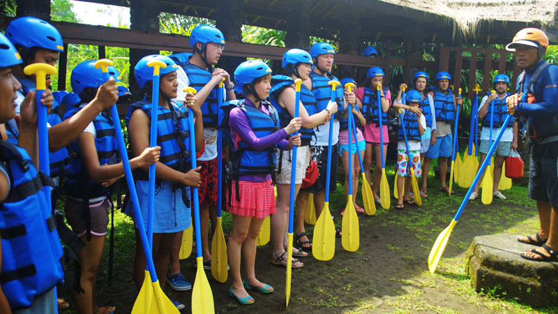 Rafters receiving a safety briefing before embarking on a Bali river rafting adventure.