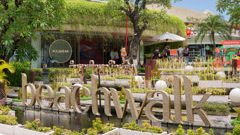 Beach Walk sign in front of the lush, stylish facade of Beach Walk Mall Kuta, Bali