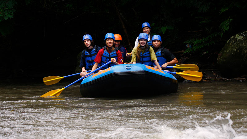 Group enjoying a serene rafting experience on the Ayung River in Ubud, Bali.