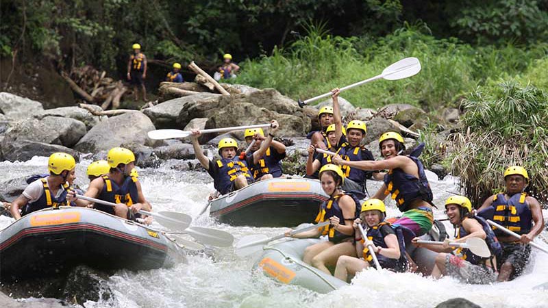 Group of rafters navigating the rapids on Ayung River in Ubud, Bali, showcasing the family-friendly adventure with Mason Adventure Rafting.