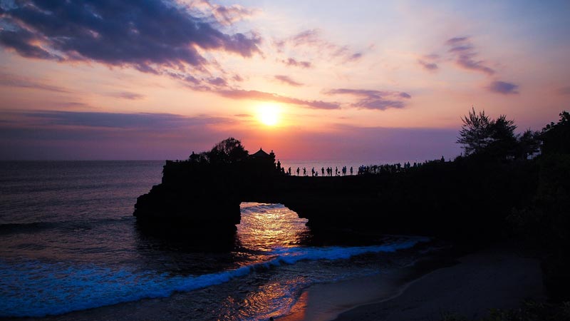 Sunset view at Tanah Lot Temple with silhouette of the shrine against the sky. Bali Top Temples Guide