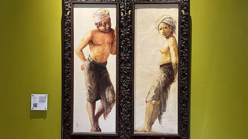 Paintings of Balinese man and woman in traditional attire at Neka Art Museum