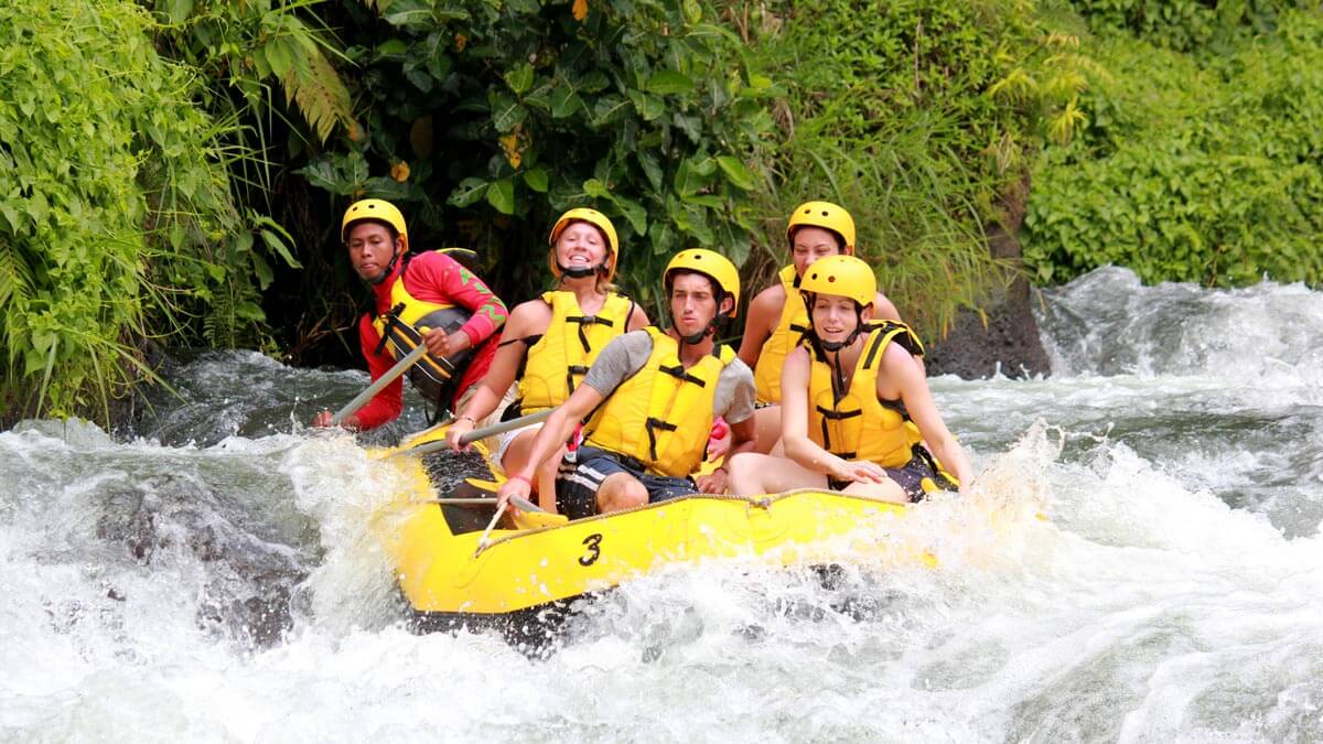 Group rafting through river rapids in Bali