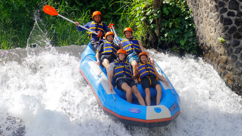 Rafting group navigating the vibrant Telaga Waja River rapids in East Bali.