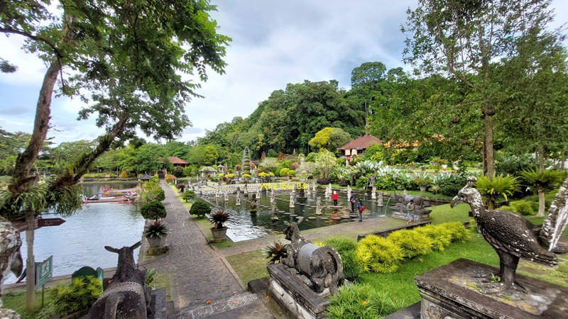 Lush gardens and stone pathways of Tirta Gangga Water Palace in East Bali