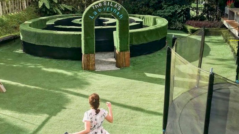 Child observing the green labyrinth at SILA'S Agrotourism in Bedugul, Bali.