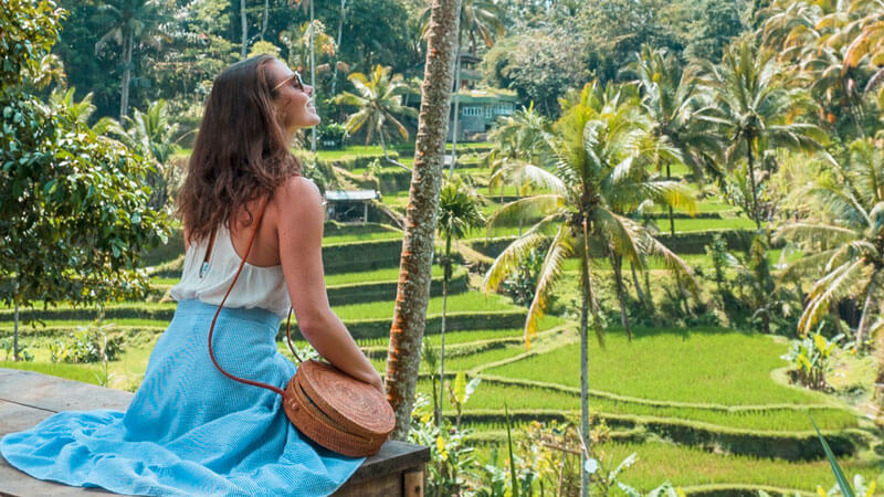 Visitor admiring the lush Tegallalang Rice Terraces in Ubud