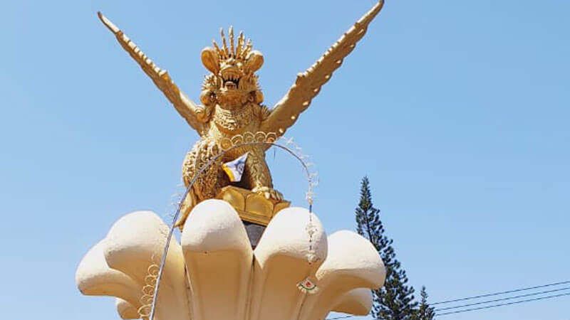 Golden Patung Singa Ambara Raja statue against a clear blue sky in North Bali