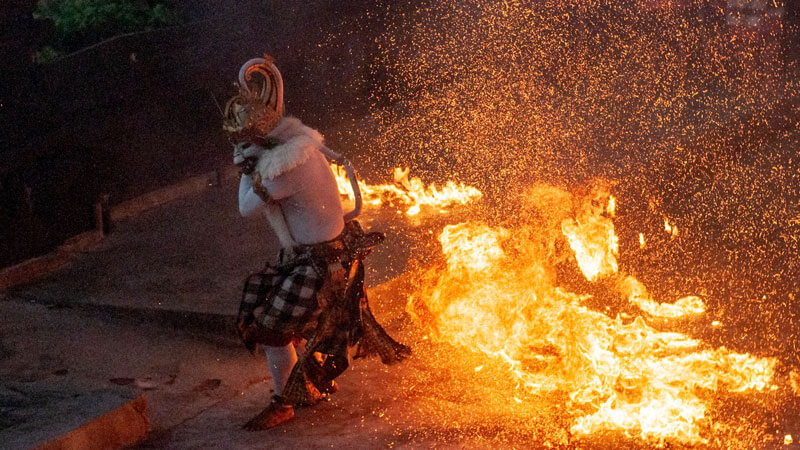 Traditional Kecak Fire Dance performer in action at Uluwatu Temple, Bali