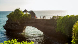 Visitors at Batu Bolong Temple with its unique rock arch over the sea