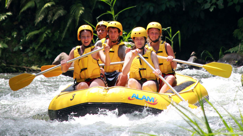 Telaga Waja Class II–III wave train with guide and beginners wearing helmets