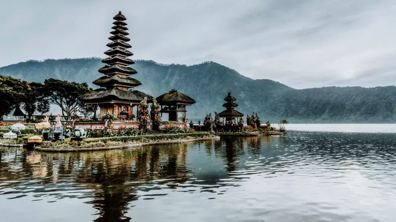 Floating Ulun Danu Beratan Temple Bali with mountain reflection on Lake Beratan.
