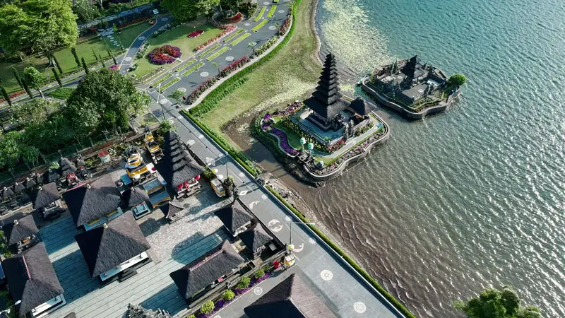 Aerial view of Ulun Danu Beratan Temple showing parking, footpaths, and lake.