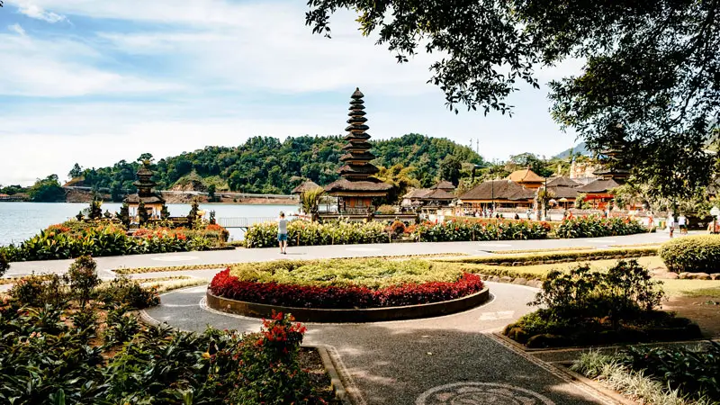 Flat paved path and flower garden near The floating temple in Bedugul, accessible for strollers and wheelchairs.