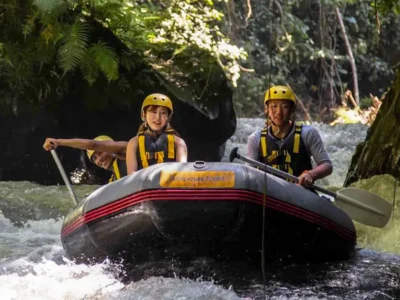 Two travelers rafting calmly through Bali’s Ayung River jungle