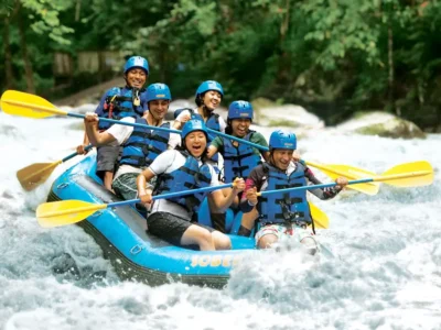 Smiling group rafting on Ayung River in Bali during a scenic and safe white water adventure
