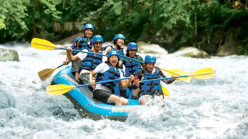 Group rafting on Ayung River in Ubud, enjoying a safe, fun ride through jungle rapids with a local guide.