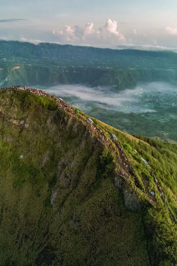Aerial view of Mount Batur ridgeline and misty Kintamani caldera at sunrise