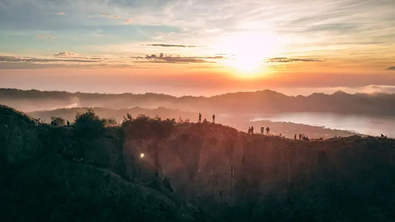 Trekkers watching sunrise over Mount Batur ridge – a highlight from the Mount Batur Sunrise Trek Guide