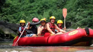 Family with children and guide rafting safely on Ayung River in full safety gear