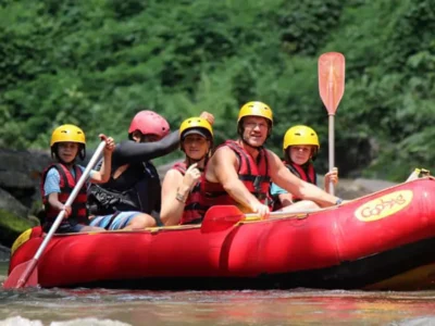 Family with children and guide rafting safely on Ayung River in full safety gear
