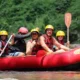 Family with children and guide rafting safely on Ayung River in full safety gear