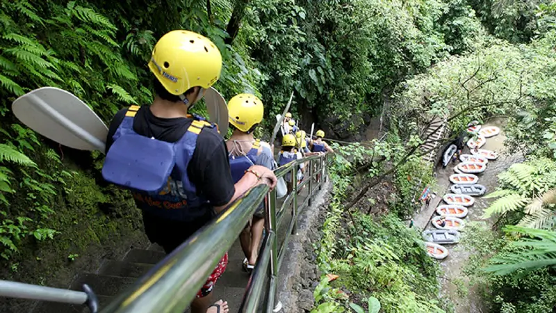 Guests descending stone steps through jungle trail to reach Ayung River rafting start point