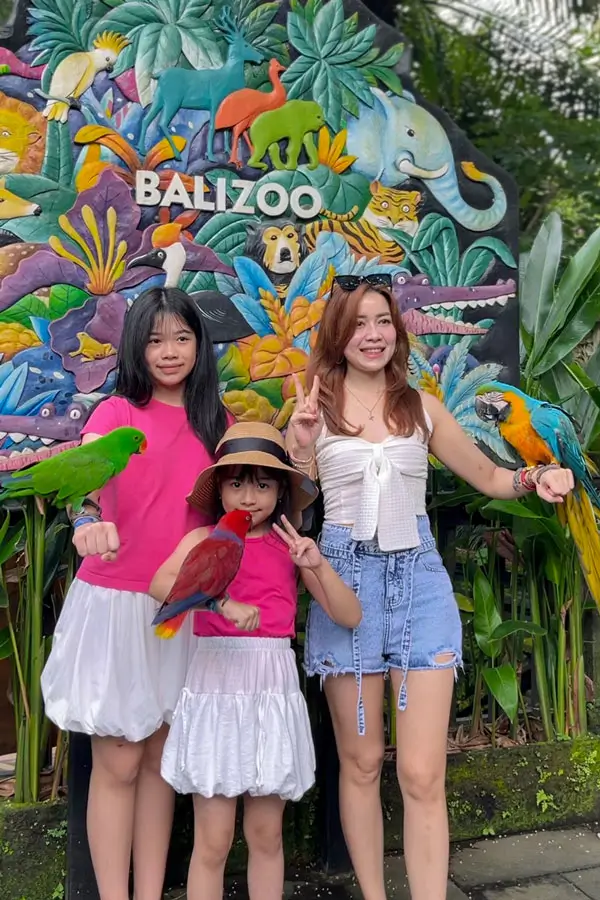 Posing with parrots at zoo photo wall