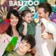 Family with kids posing with parrots at Bali Zoo photo zone
