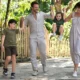 Family walking together on shaded path at Bali Zoo with young children
