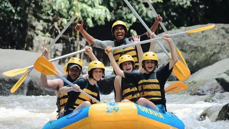 Smiling group with guide after completing Ayung River rafting in full safety gear