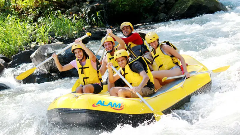 Group wearing quick-dry clothing while white water rafting in Bali