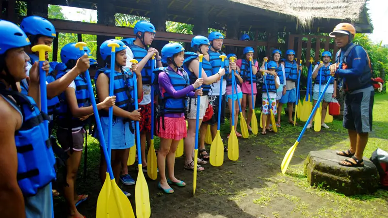 Sobek Telaga Waja rafting safety briefing with guide explaining paddling basics to guests before launch in East Bali.