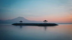 Sunrise calm water at an east-side bay in Bali in December with Mount Agung silhouette
