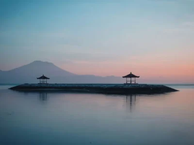 Sunrise calm water at an east-side bay in Bali in December with Mount Agung silhouette