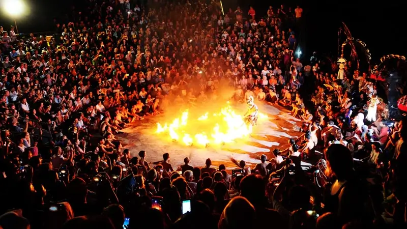 Circle of Kecak performers with fire after dark at 19:00