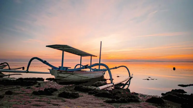 Traditional jukung boat at sunrise on Matahari Terbit Beach Sanur Bali