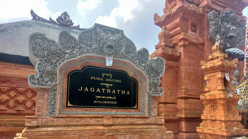 Entrance sign and red-brick shrines at Pura Agung Jagatnatha Temple Denpasar
