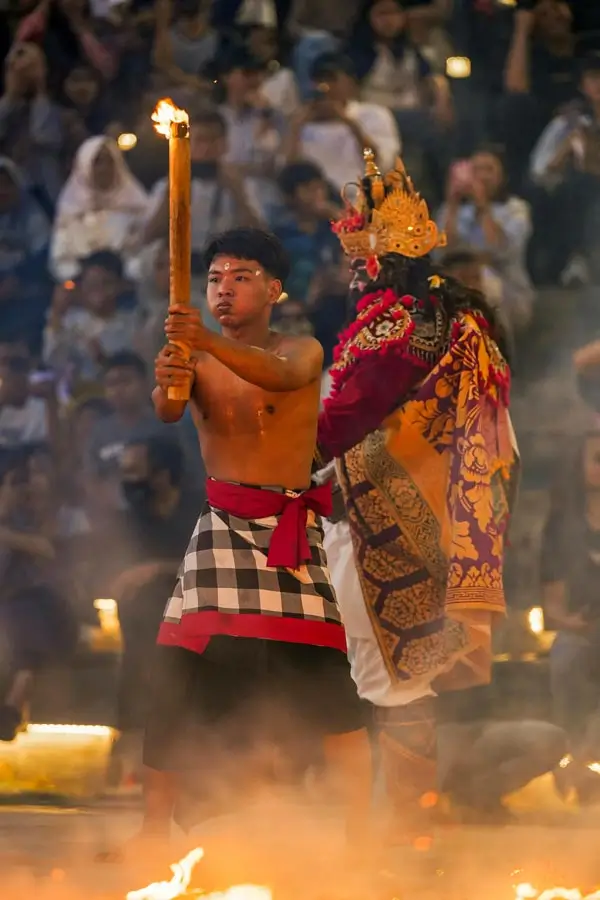 Torch bearer and character on the Kecak stage