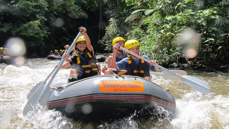 Family with kids enjoying white water rafting on Ayung River Bali