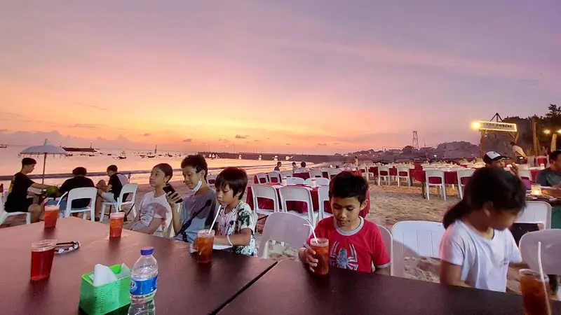 Kids at Jimbaran beach dinner at sunset