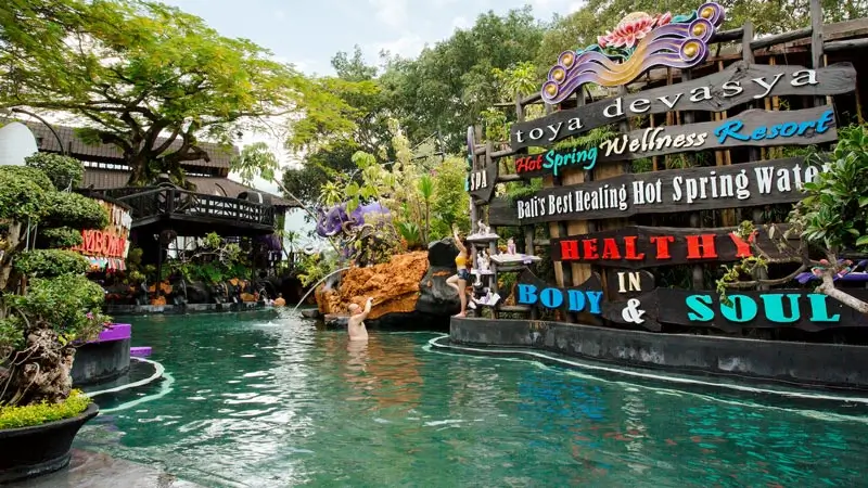 Toya Devasya hot spring wellness resort sign by the pool