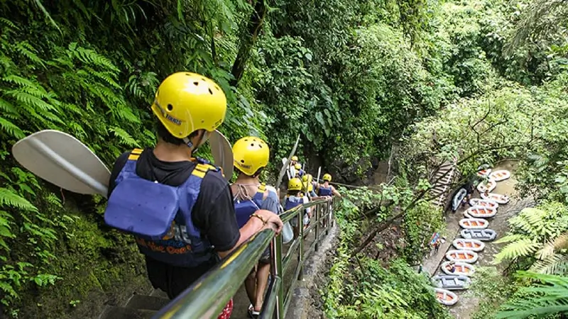 Participants walking down stairs to the rafting start point in Ubud