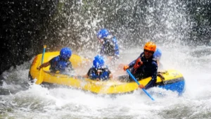 Sobek Telaga Waja rafting through a waterfall splash