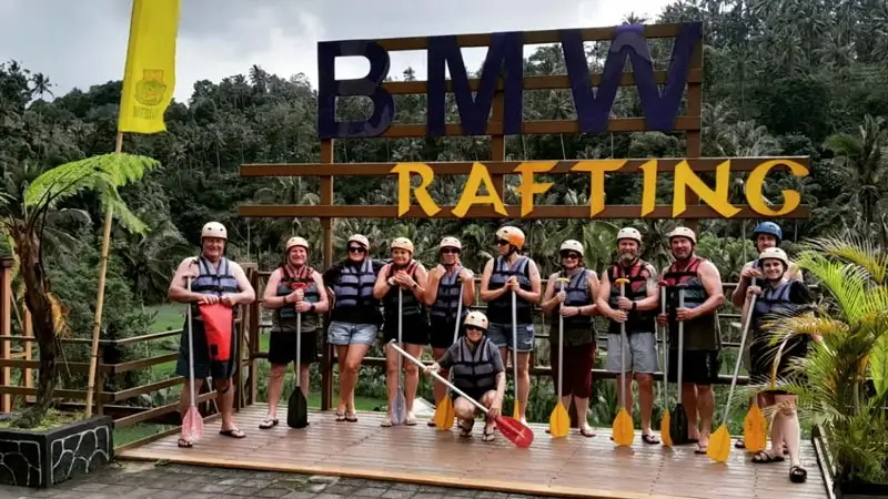 Group photo at the BMW Rafting sign before the activity
