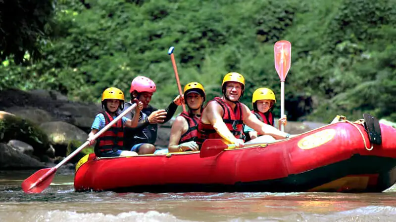 Family group in a red raft on a calmer river section
