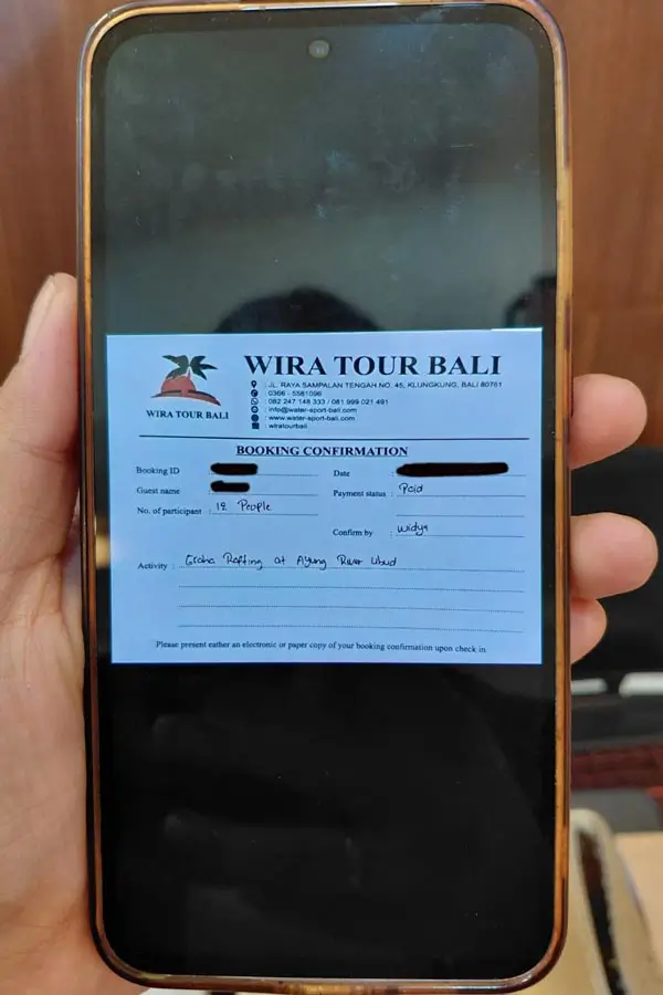 Graha Adventure Rafting Ubud booking voucher on a phone