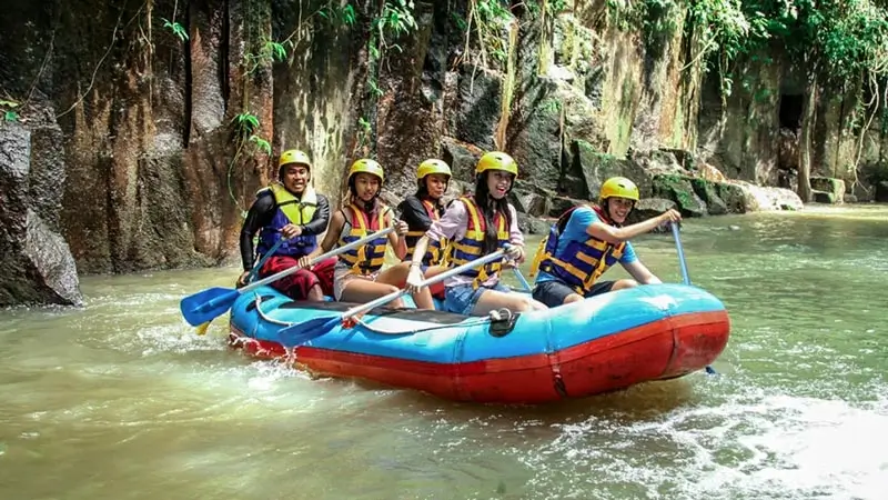 Melangit River rafting through a calmer section with rocky river walls